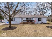 Charming one-story home with a light blue painted brick exterior, a front deck, and a well-manicured front yard at 5445 Elderberry Rd, Noblesville, IN 46062