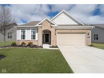 Charming brick home featuring an attached two-car garage and a well-manicured front lawn at 568 Harstad Blvd, Westfield, IN 46074