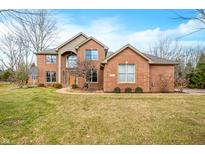 Charming two-story brick home with manicured lawn and beautiful architectural details at 6002 Turtle Bay Pkwy, Columbus, IN 47201