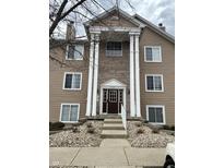 Charming three-story exterior with stone and tan facade, and large columns framing the entryway at 6526 Jade Stream Ct # 309, Indianapolis, IN 46237