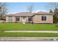 Charming brick home with manicured lawn and inviting front entrance at 6528 Hedback Dr, Indianapolis, IN 46220
