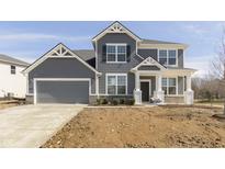 Charming two-story home with gray siding, stone accents, attached two car garage, and well-manicured front yard at 7181 Barrett Dr, Brownsburg, IN 46112
