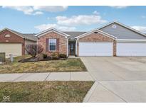 Charming brick home with a well-maintained lawn and an attached two-car garage at 7848 Cork Bend Ln, Indianapolis, IN 46239