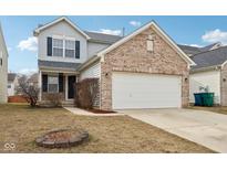 Charming two-story home with brick accents, a two-car garage, and a cozy front yard fire pit at 8074 Carina Dr, Indianapolis, IN 46268