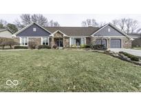 Charming brick home with a well-maintained front yard and attached two-car garage at 8901 Rocky Ridge Rd, Indianapolis, IN 46217