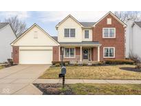 Charming two-story home with a brick and siding exterior, attached garage, and well-manicured front lawn at 11866 Weathered Edge Dr, Fishers, IN 46037