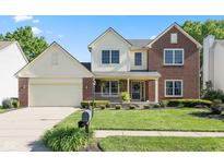 Charming two-story home with a well-manicured lawn, complemented by a welcoming front porch and a two-car garage at 11866 Weathered Edge Dr, Fishers, IN 46037