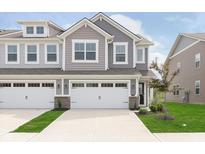 New construction home featuring attached two-car garage and manicured lawn at 1231 Langham St, Avon, IN 46123