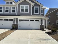 Two-car garage with white door and gray siding, set on a concrete driveway at 1231 Langham St, Avon, IN 46123