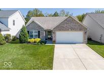 Charming brick home with a well-manicured lawn and two-car garage, creating an inviting curb appeal at 14963 Mia Dr, Carmel, IN 46033