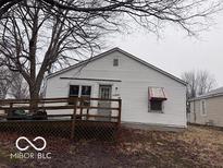Cozy single-story home with a welcoming deck, mature tree, and a classic, neutral-toned exterior at 1900 E Purdue Rd, Muncie, IN 47303
