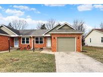 Charming brick home featuring an attached garage and a well-maintained front yard at 2184 Galaxy Dr, Franklin, IN 46131
