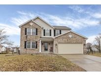 Charming two-story home featuring a brick facade, an attached two-car garage and a well-maintained front yard at 249 Fairfax Ln, Greenwood, IN 46142