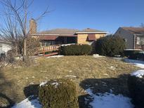 Charming brick home with landscaped yard, chimney, and accessibility ramp at 3425 Forest Manor Ave, Indianapolis, IN 46218