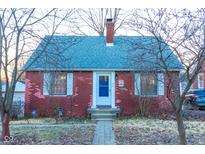 Charming brick home featuring a blue door, complemented by white trim and inviting curb appeal at 36 Bankers Ln, Indianapolis, IN 46201