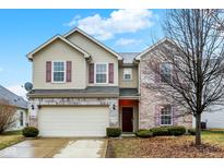 Charming two-story home with a two-car garage, brick and siding exterior, and well-maintained landscaping at 3844 Kilburn Ct, Indianapolis, IN 46228