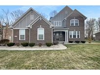 Charming two-story brick home featuring a well-manicured front yard and inviting entrance at 3927 Harrison Crossing Ln, Greenwood, IN 46142