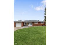 Charming single-story brick home with a well-maintained lawn and inviting curb appeal at 424 Simmons St, Plainfield, IN 46168