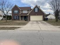 Charming two-story brick home with attached two car garage and a well manicured lawn at 457 Prince Dr, Greenwood, IN 46142