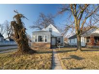 Charming home with a neatly kept front yard and mature trees, offers classic curb appeal at 5068 W 10Th St, Indianapolis, IN 46224