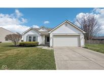 Charming one-story home boasts a well-manicured lawn and a two-car attached garage at 664 Beaverbrook Dr, Carmel, IN 46032