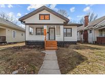 Charming bungalow featuring fresh exterior paint and a tidy front yard at 729 W 32Nd St, Indianapolis, IN 46208
