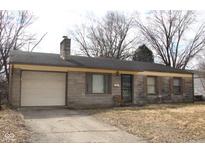Charming single-story home with stone exterior, attached garage and driveway at 7625 E 35Th St, Indianapolis, IN 46226
