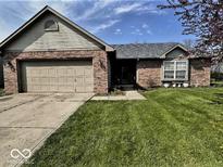 Charming single-story home with a brick facade, well-maintained lawn, and attached two-car garage at 8076 Captain Dr, Avon, IN 46123