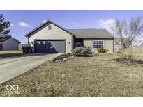 Charming single-story home featuring a two-car garage, landscaped front yard, and neutral siding at 954 W Palomino Pl, Bargersville, IN 46106