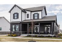 Inviting two-story home showcasing a covered front porch and modern black and white design at 1225 Amberley Way, Westfield, IN 46074