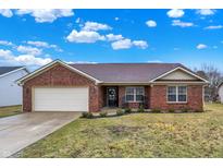 Charming brick ranch with attached garage, covered entryway, and landscaped front yard at 13 Watson Dr, Trafalgar, IN 46181