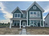 Beautiful craftsman-style home featuring green siding, brick accents, and white trim at 13610 Grand Abbey Way, Fishers, IN 46037