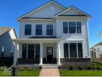 Charming two-story home featuring white siding, black window frames, a brick foundation, and a welcoming front porch at 13622 Grand Abbey Way, Fishers, IN 46037