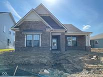 New brick single-Gathering home featuring a covered entry, and a gable roof, awaiting landscaping at 13634 Grand Abbey Way, Fishers, IN 46037