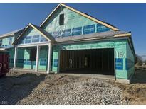 New construction home with a large two-car garage and a covered front porch at 1366 Foxtail Ln, Greenwood, IN 46143