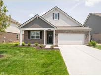 Charming single-Gathering home with manicured lawn, brick accents, and a two-car garage in a suburban neighborhood at 1366 Foxtail Ln, Greenwood, IN 46143