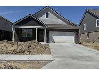 New construction home featuring a brick facade, attached two-car garage, and a concrete driveway at 1366 Foxtail Ln, Greenwood, IN 46143