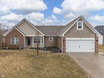 Charming single-story home with brick and shake siding, a well-maintained lawn, and attached garage at 26 Downing Dr, Trafalgar, IN 46181