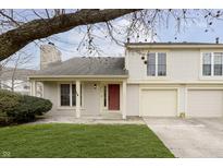 Inviting two-story home with attached garage, well-kept lawn, and appealing landscaping at 2619 Chaseway Ct, Indianapolis, IN 46268