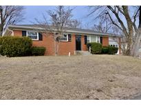 Charming brick home with well-maintained landscaping, black shutters, and a cozy front porch at 3422 Ferncliff Ave, Indianapolis, IN 46227
