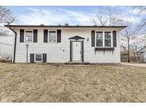 Charming two-story home with a white exterior, black shutters, and a well-manicured lawn at 4249 Dubarry Rd, Indianapolis, IN 46226