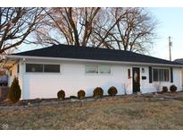 Charming single-story home featuring white siding, a black roof, and manicured landscaping at 516 Northfield Dr, Lebanon, IN 46052