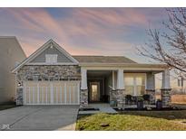 Charming single-Gathering home with stone accents, covered porch, and two-car garage at 5751 Bluff View Ln, Whitestown, IN 46075
