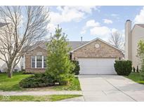 Charming single-story brick home with a well-manicured lawn and an attached two-car garage at 6537 Amherst Way, Zionsville, IN 46077