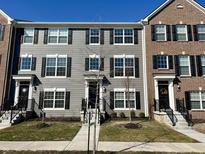 Charming townhome with a manicured lawn, complemented by black shutters and a welcoming entrance at 6882 Equality Blvd, Carmel, IN 46033