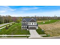 Beautiful two-story home with well-manicured lawn and a long driveway leading to a two-car garage at 7450 Leatherwood Dr, Indianapolis, IN 46259