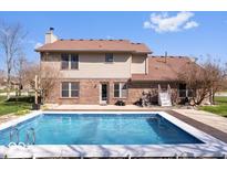Inviting backyard features a sparkling in-ground pool, perfect for outdoor enjoyment and relaxation at 8333 Hunters Meadow Ct, Indianapolis, IN 46259