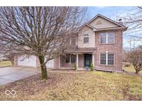 Beautiful two-story brick home with well-maintained lawn and mature trees at 8333 Hunters Meadow Ct, Indianapolis, IN 46259