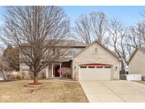 Charming two-story home with brick and a two car garage, front lawn, and beautiful landscaping at 1023 N Quiet Bay Cir, Cicero, IN 46034