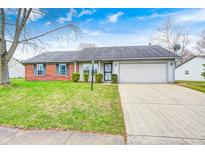 Charming single-story home featuring a well-maintained front yard and attached two car garage at 11363 Kristen Ln, Indianapolis, IN 46235